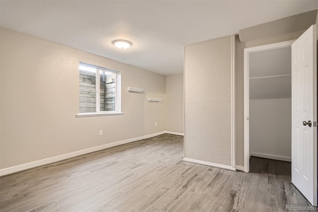 3401 W Milan Ave, Denver, CO 80236 - unfurnished bedroom with wood finished floors and baseboards
