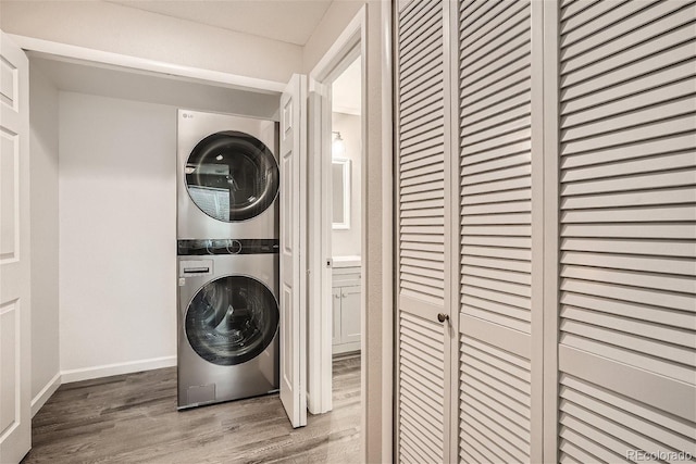 3401 W Milan Ave, Denver, CO 80236 - washroom with stacked washer / dryer, wood finished floors, and baseboards