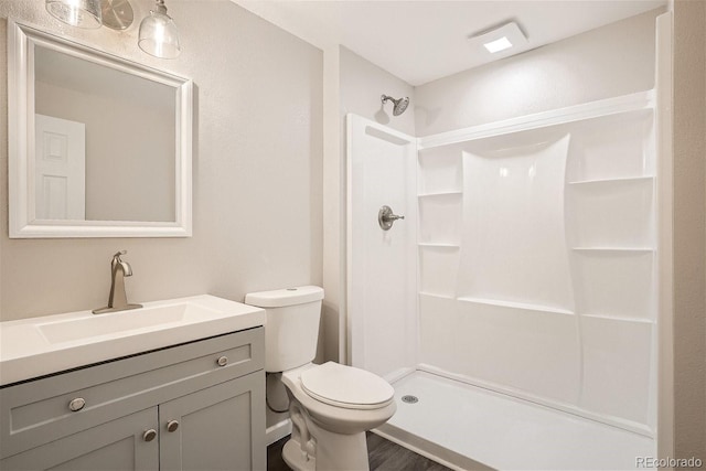3401 W Milan Ave, Denver, CO 80236 - full bath with toilet, a stall shower, vanity, and wood finished floors