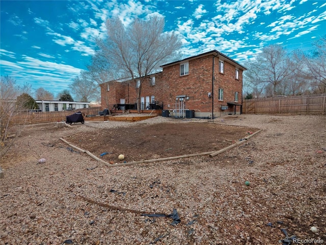 3401 W Milan Ave, Denver, CO 80236 - rear view of property featuring a fenced backyard and brick siding