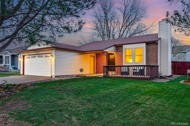 ranch-style home featuring concrete driveway, an attached garage, a chimney, and a yard