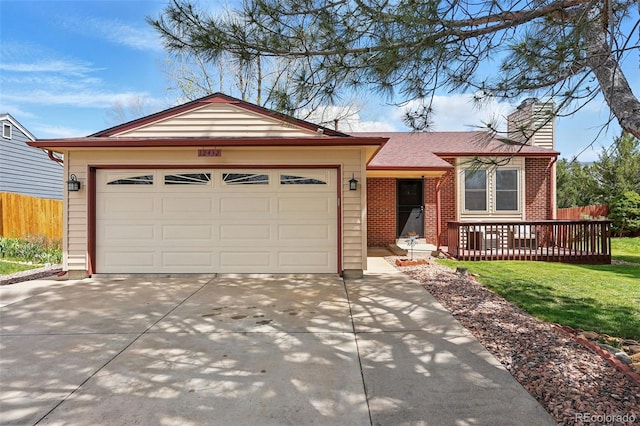 view of front of house featuring a chimney, a front yard, brick siding, fence, and concrete driveway