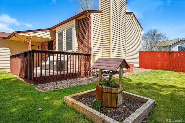 exterior space with fence and a deck