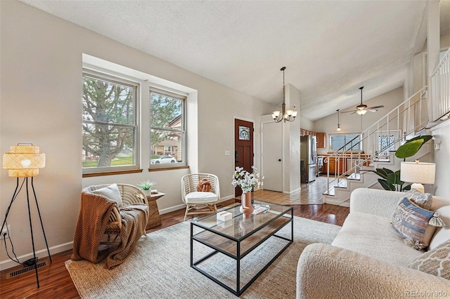 living room featuring baseboards, a ceiling fan, stairs, and wood finished floors