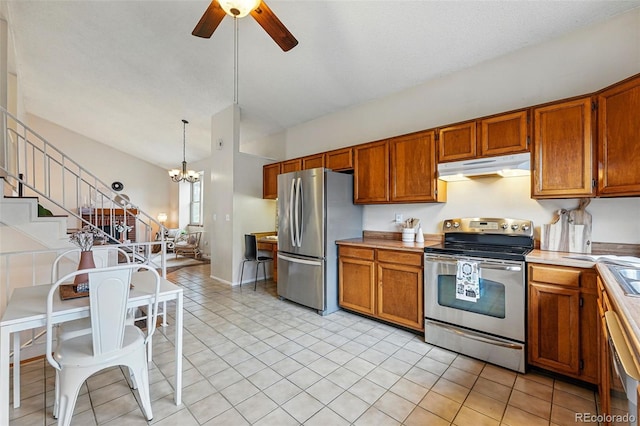 kitchen with brown cabinetry, ceiling fan with notable chandelier, appliances with stainless steel finishes, and under cabinet range hood