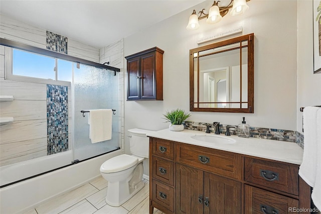 full bathroom with toilet, enclosed tub / shower combo, tile patterned flooring, and vanity