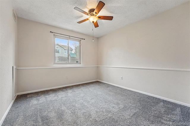 carpeted empty room with baseboards, a textured ceiling, and ceiling fan