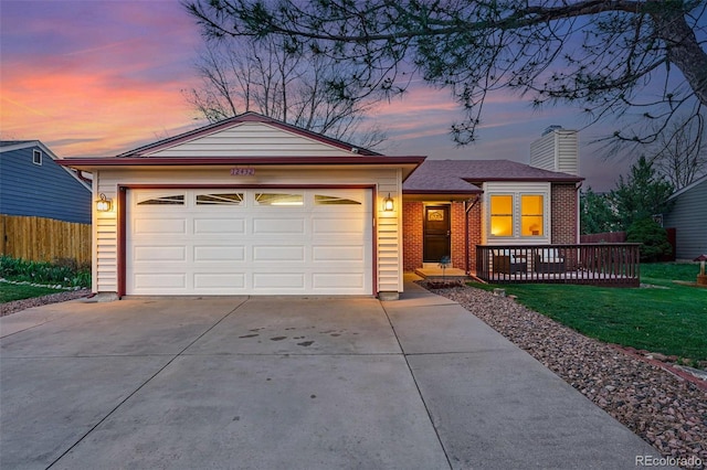 ranch-style home featuring an attached garage, fence, a chimney, concrete driveway, and a lawn