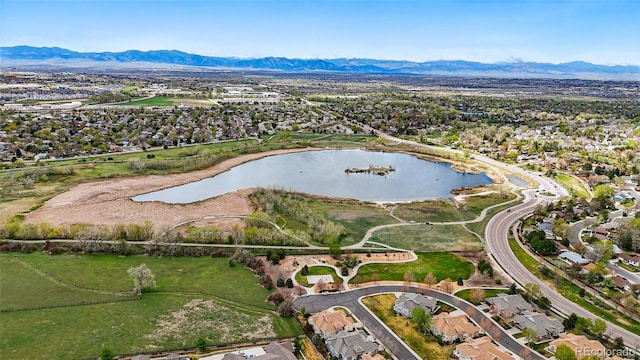 drone / aerial view featuring a residential view and a water and mountain view