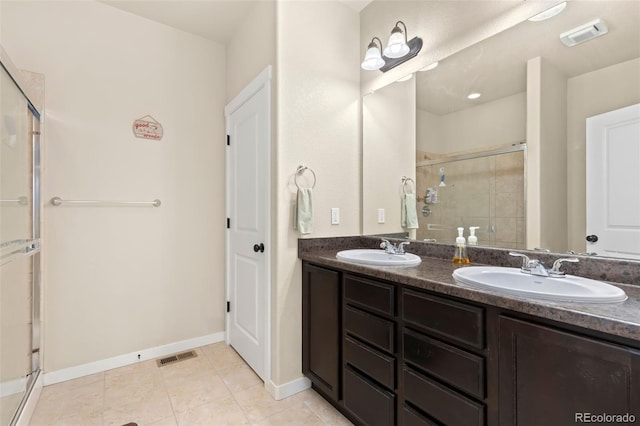 bathroom featuring vanity, tile patterned floors, and a shower with shower door