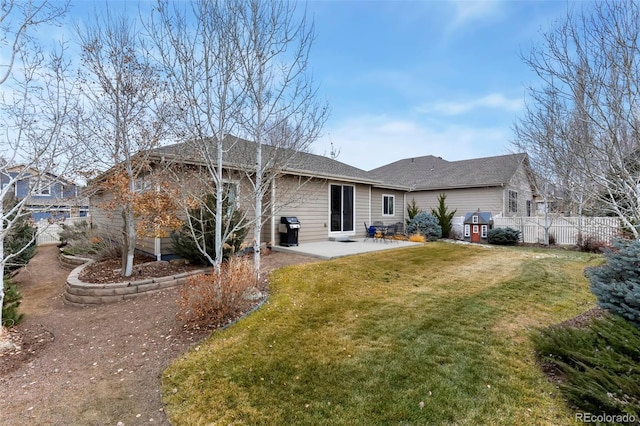 rear view of house with a lawn and a patio area