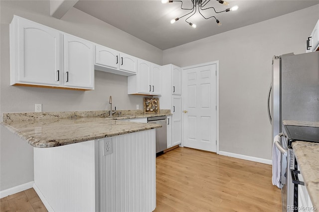 kitchen with a peninsula, light stone countertops, baseboards, white cabinetry, and appliances with stainless steel finishes
