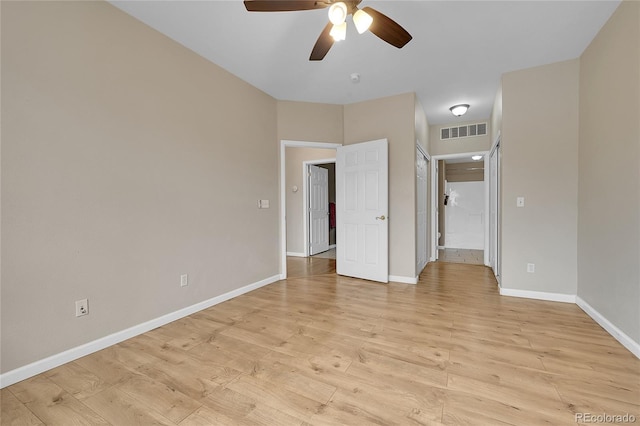 unfurnished bedroom with a ceiling fan, baseboards, visible vents, and light wood-style floors