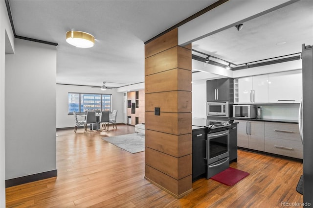 kitchen with white cabinetry, hardwood / wood-style flooring, ceiling fan, and appliances with stainless steel finishes