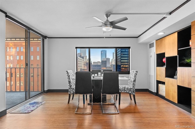 dining area featuring ceiling fan, crown molding, and light hardwood / wood-style floors