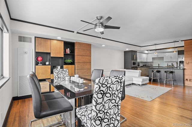 dining space featuring ceiling fan and light hardwood / wood-style flooring