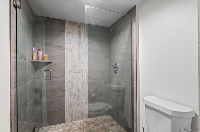 bathroom with an enclosed shower and toilet