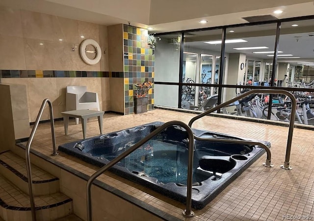 1551 Larimer St Unit 1106, Denver, CO 80202 - exercise room featuring tile walls and recessed lighting