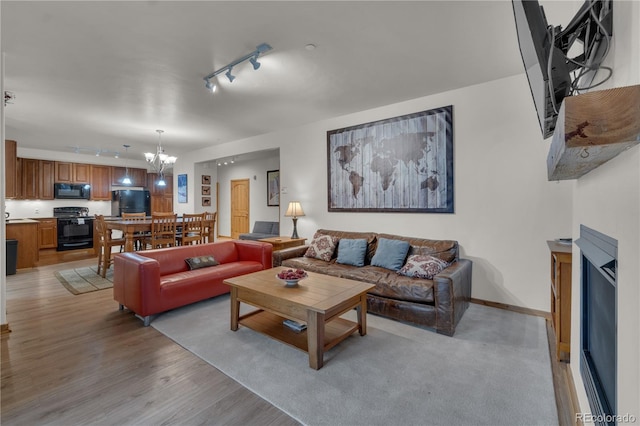 801 Trailhead Cir Unit 812, Winter Park, CO 80482 - living area featuring track lighting, light wood-style flooring, and a chandelier