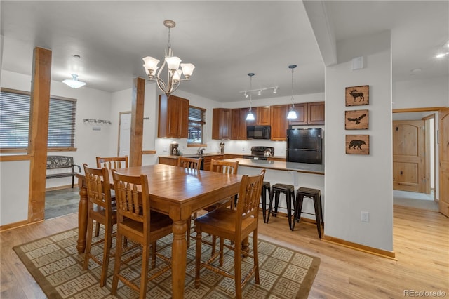 801 Trailhead Cir Unit 812, Winter Park, CO 80482 - dining area featuring light wood-style flooring, a chandelier, and rail lighting