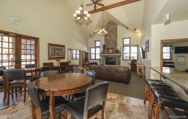 801 Trailhead Cir Unit 812, Winter Park, CO 80482 - dining room with high vaulted ceiling, a chandelier, light stone finish floors, a fireplace, and beam ceiling
