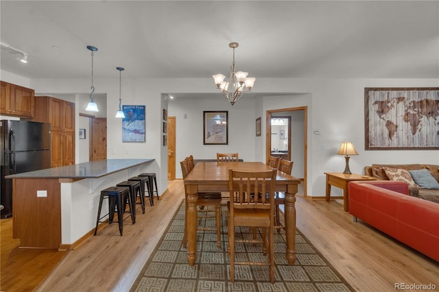 801 Trailhead Cir Unit 812, Winter Park, CO 80482 - dining room featuring light wood finished floors and a chandelier