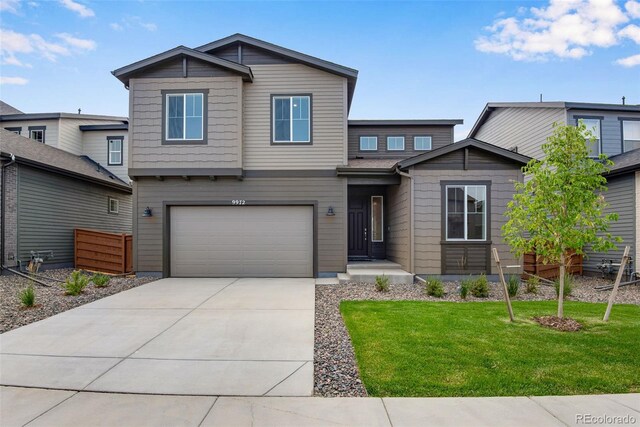 view of front of home with a garage and a front yard