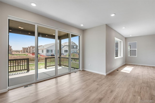 unfurnished room with light wood-type flooring