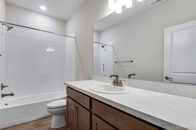 full bathroom featuring vanity, bathtub / shower combination, wood-type flooring, and toilet