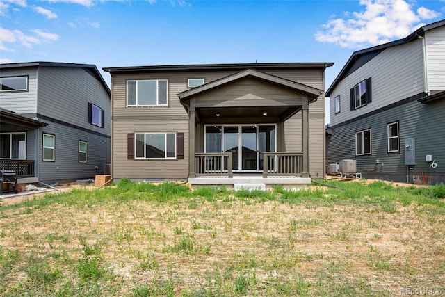 rear view of property featuring a lawn