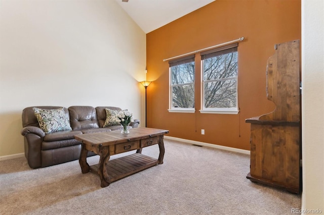 carpeted living room featuring high vaulted ceiling