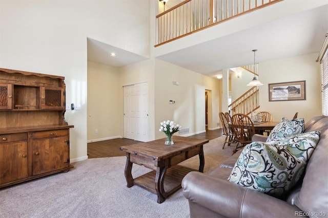 carpeted living room featuring a high ceiling