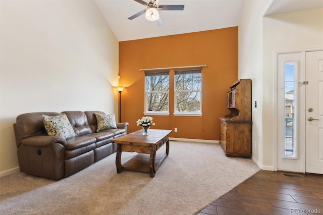 living room featuring hardwood / wood-style flooring, ceiling fan, and high vaulted ceiling