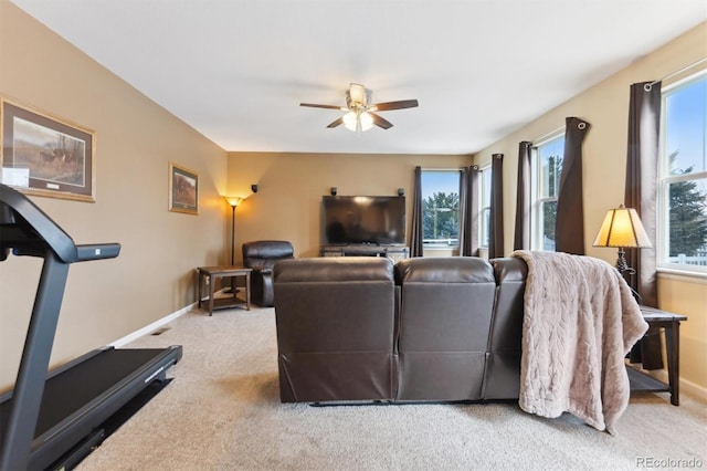 carpeted living room with ceiling fan