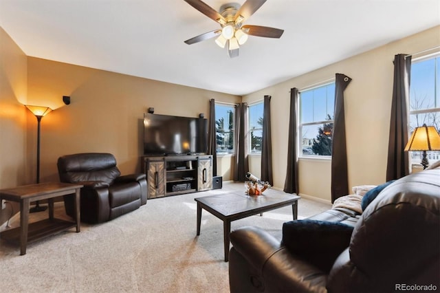 carpeted living room with ceiling fan