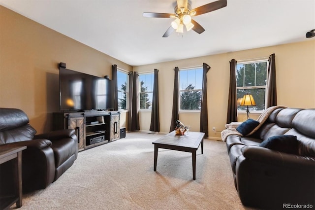 carpeted living room with ceiling fan