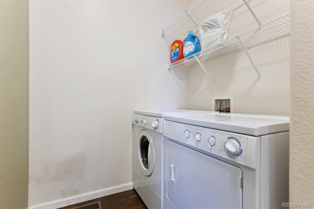 washroom featuring dark hardwood / wood-style floors and washer and dryer