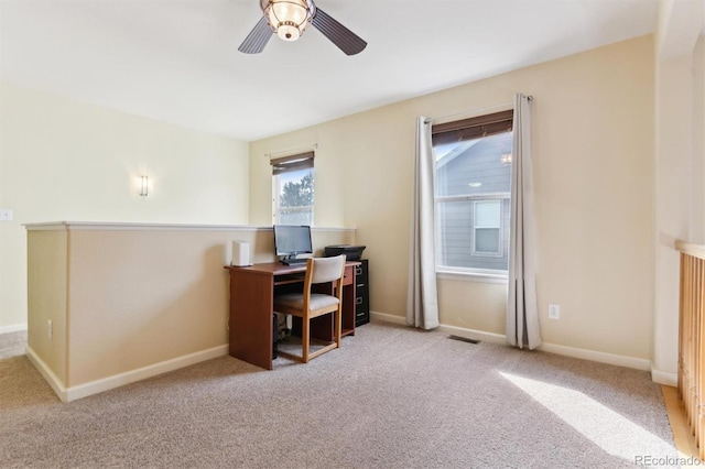 home office with light carpet and ceiling fan