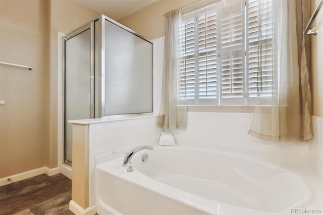 bathroom with hardwood / wood-style flooring, a wealth of natural light, and independent shower and bath