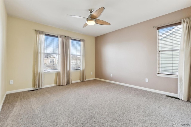 empty room with ceiling fan and carpet floors