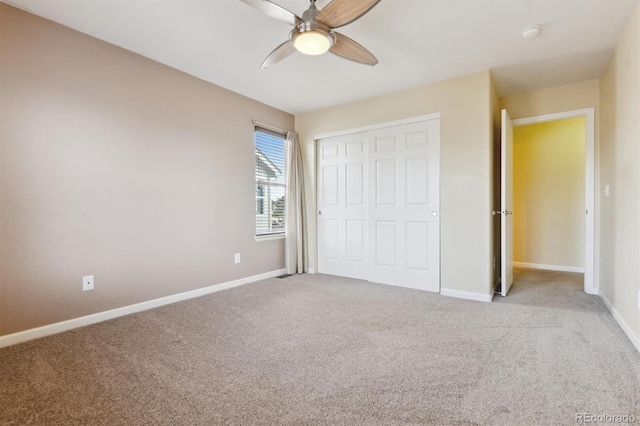 unfurnished bedroom with light colored carpet, ceiling fan, and a closet