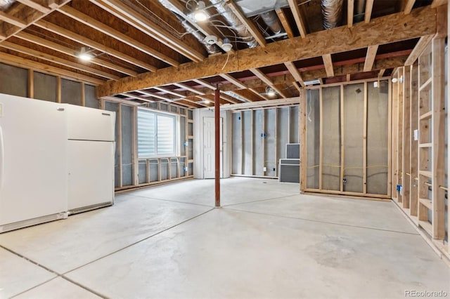 basement with white refrigerator