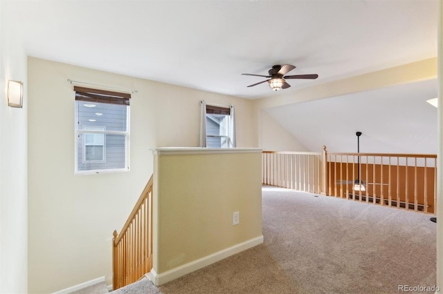 corridor with vaulted ceiling and carpet floors