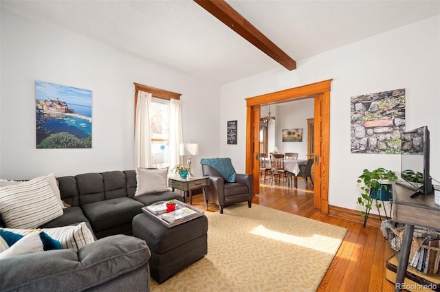 living room with beam ceiling and hardwood / wood-style flooring