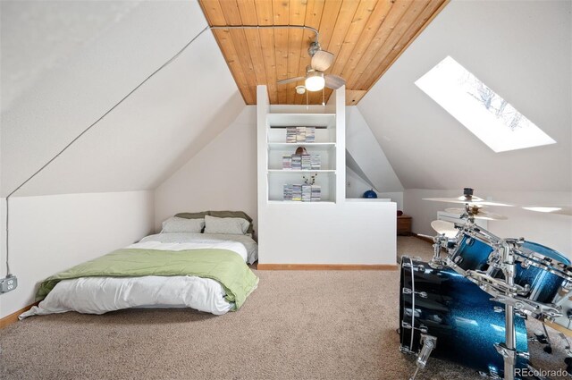 bedroom featuring lofted ceiling with skylight, carpet, and wooden ceiling