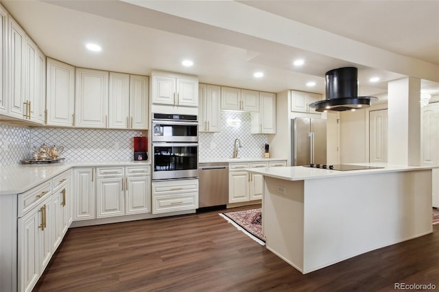 kitchen with stainless steel appliances, dark wood finished floors, light countertops, and island exhaust hood