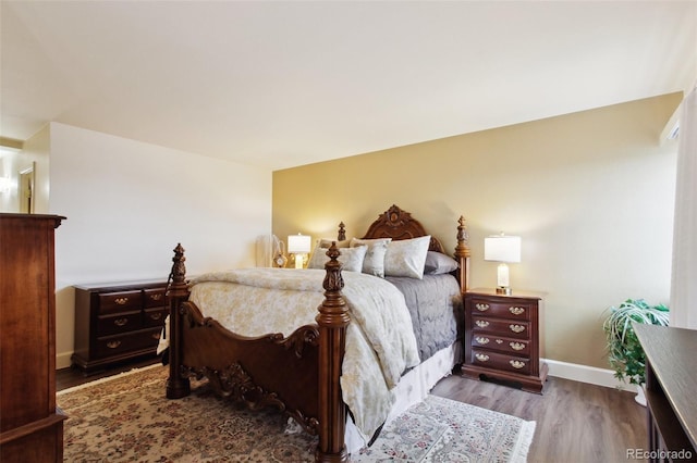 bedroom featuring baseboards and wood finished floors