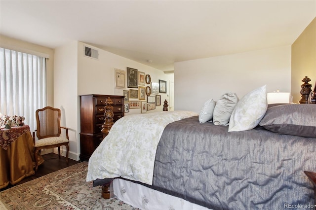 bedroom with visible vents and wood finished floors