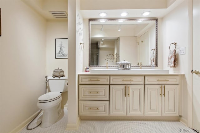 bathroom featuring toilet, baseboards, visible vents, and vanity