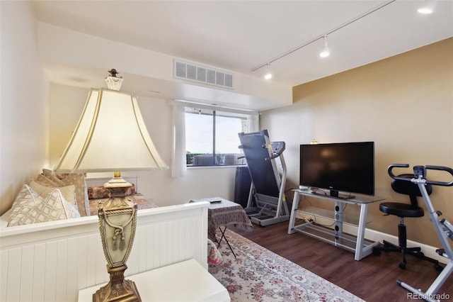 bedroom with dark wood-style flooring, visible vents, and baseboards